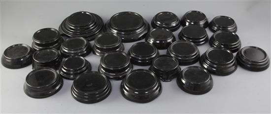 A collection of black circular glass display stands